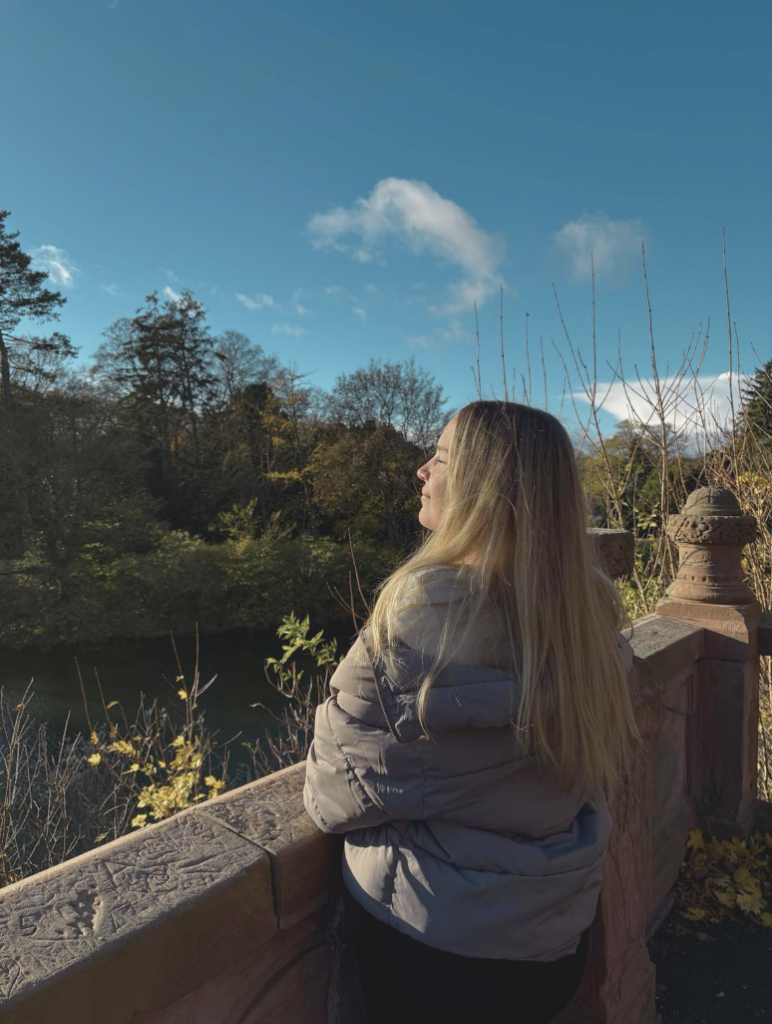 Girl looking over the water canal with sun in her face